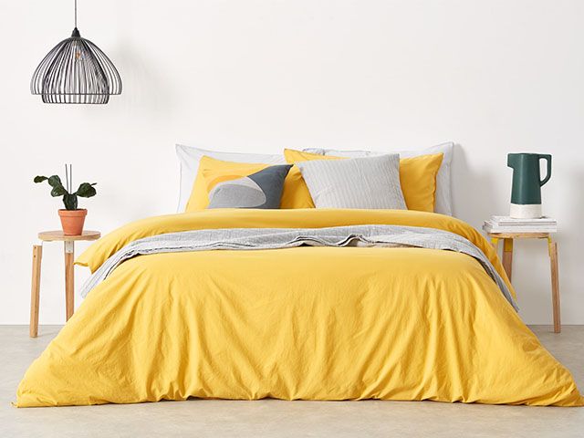 黄色的羽绒被和灰色的配件-如何在温暖的月份获得一个完美的夜晚睡眠-卧室- goodhomesmagazine.com