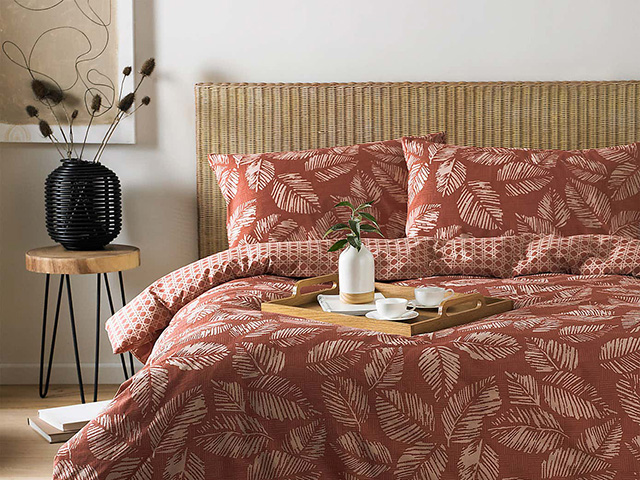 红色日本风格的床上用品在柳条床上 -  Japandi Interiors Trend  -  GoodhomesMagazine.com
