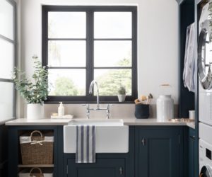 utility room with shaker style cabinets, sink and windows