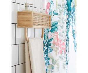 French cane rattan towel rail shelf a colourful floral shower curtain in the background - Bathroom storage - Goodhomesmagazine.com
