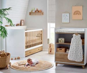 Wooden cot, rattan basket and floral rug in Laura Ashley nursery collection